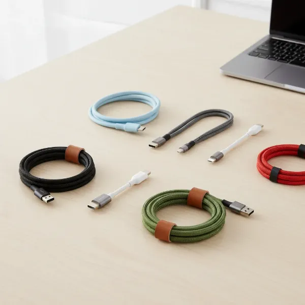 A diverse selection of charging cables from reputable brands like Anker, Belkin, and Native Union, arranged neatly on a modern surface, highlighting their varying designs and quality.
